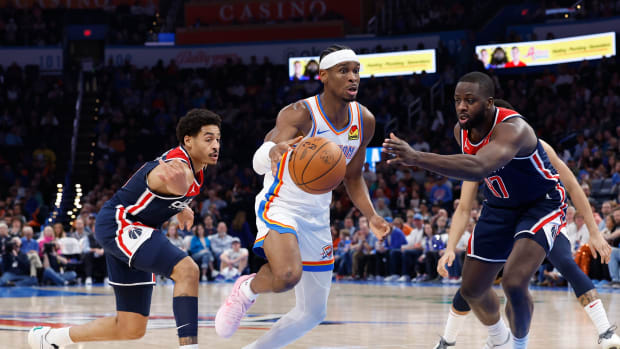 Feb 23, 2024; Oklahoma City, Oklahoma, USA; Oklahoma City Thunder guard Shai Gilgeous-Alexander (2) drives between Washington Wizards guard Jordan Poole (13) and forward Eugene Omoruyi (97) during the second half at Paycom Center. Mandatory Credit: Alonzo Adams-USA TODAY Sports